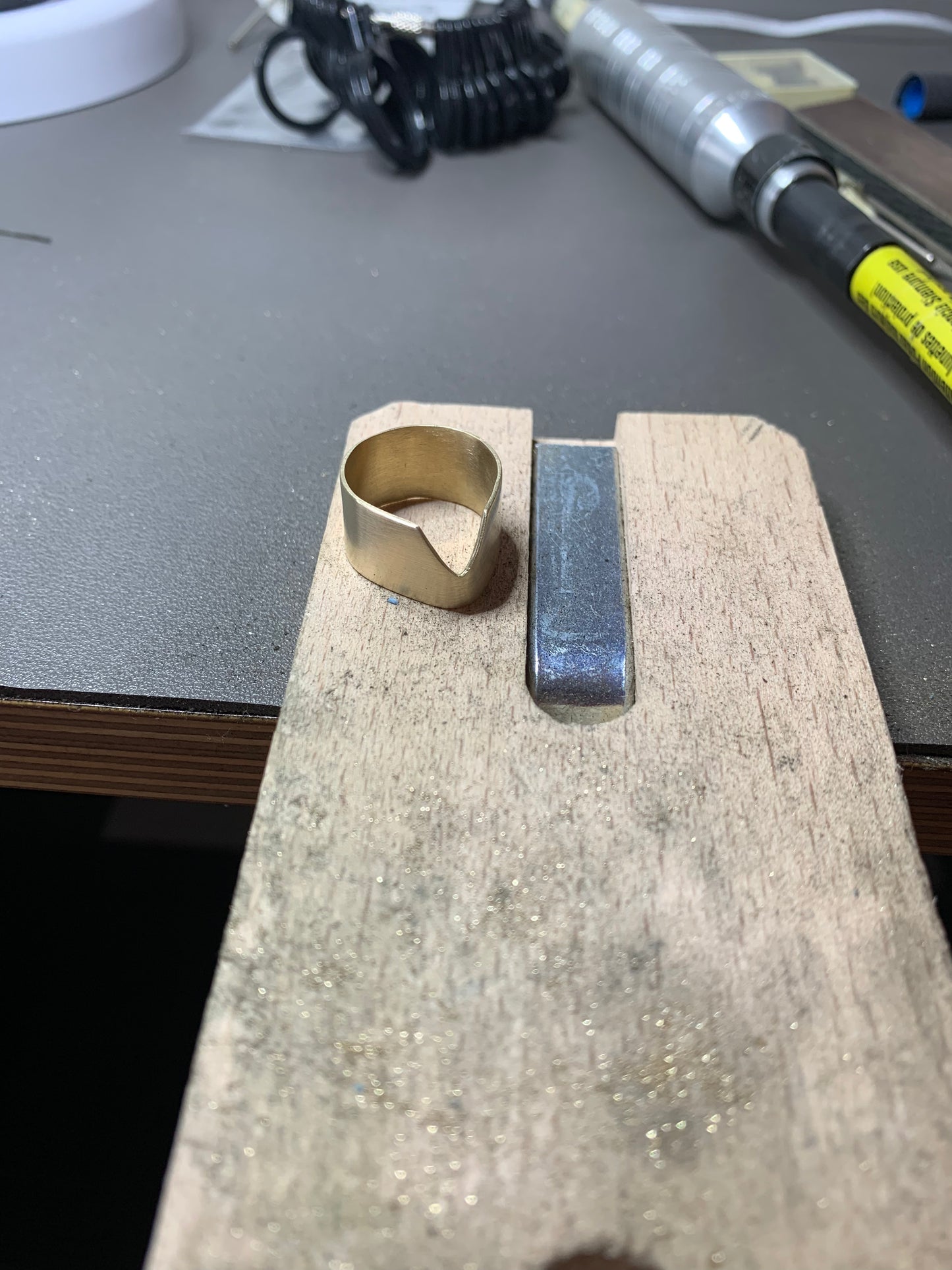Chevron Ring in eco-friendly brass, in-progress on jeweler's workbench – Black Heart Jewelers