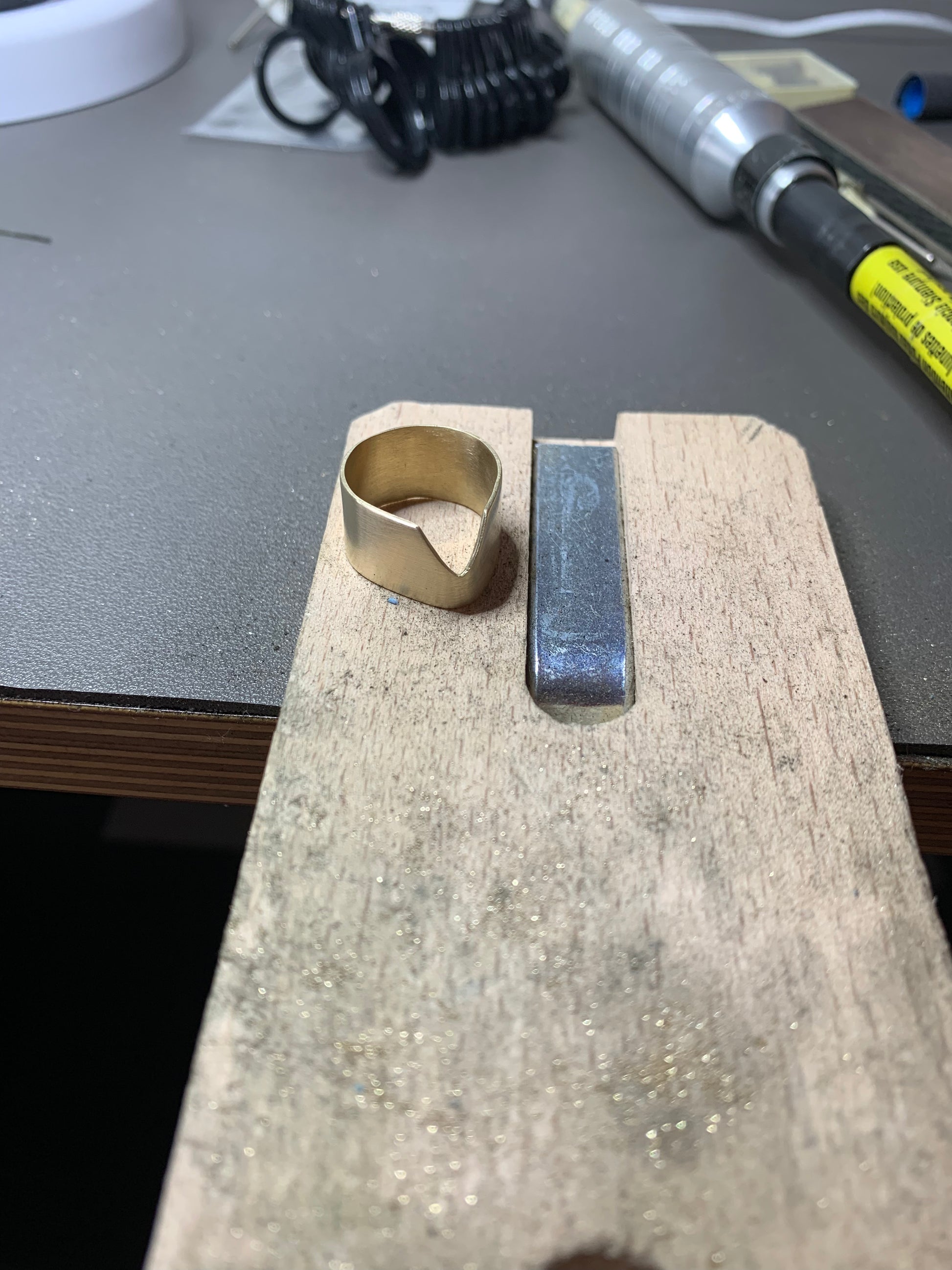 Chevron Ring in eco-friendly brass, in-progress on jeweler's workbench – Black Heart Jewelers