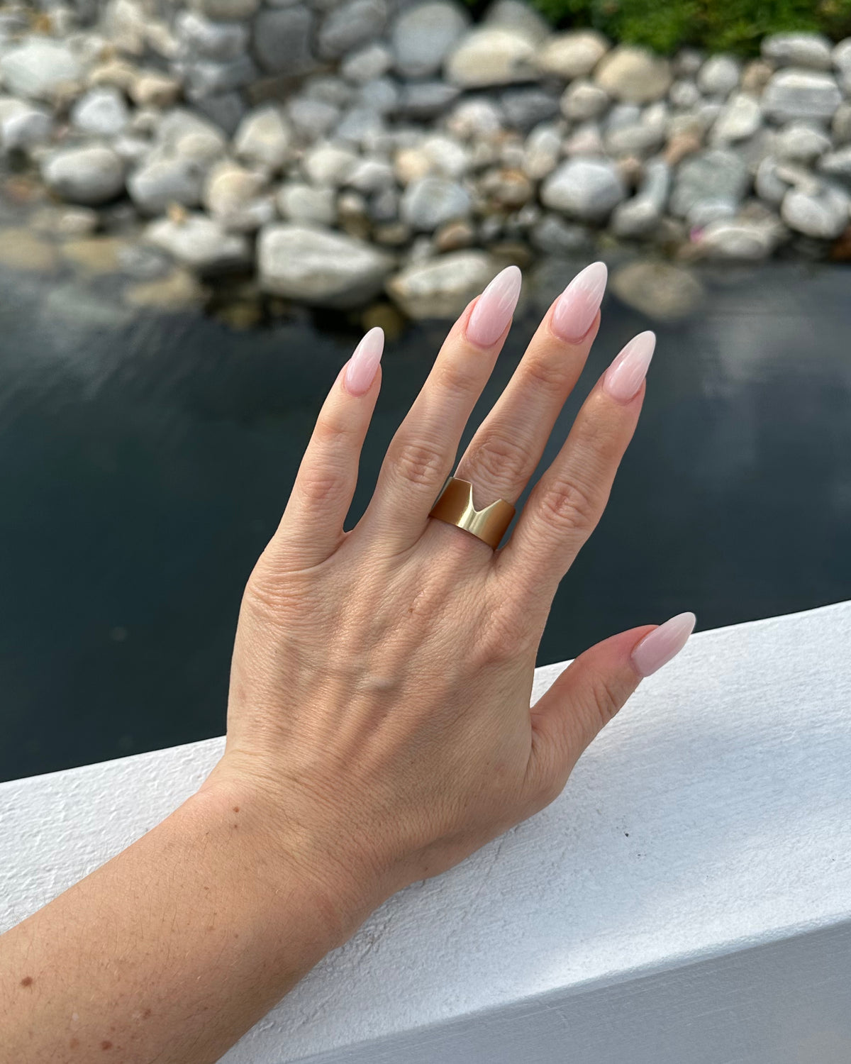 Chevron Ring in eco-friendly brass, worn on hand outdoors by water – Black Heart Jewelers