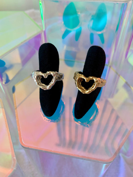 Heart Ring in eco-friendly brass and recycled sterling silver on black velvet ring holders with colorful geometric prism props – Black Heart Jewelers
