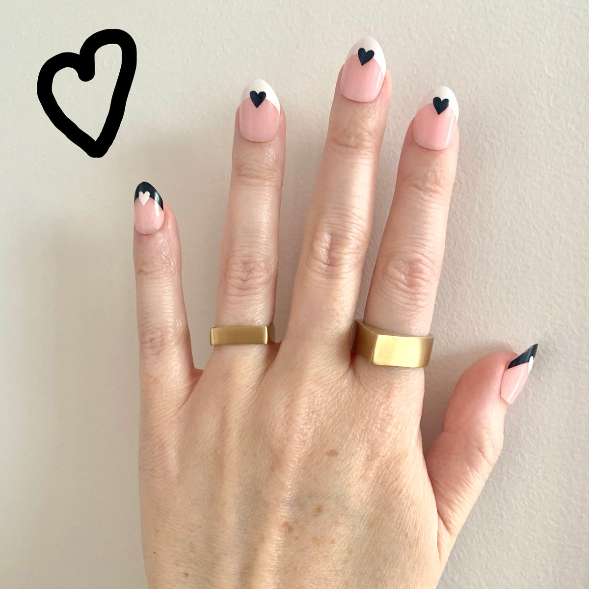 Pyramid Ring and Square Band Ring in eco-friendly brass, worn on hand with black heart nail art – Black Heart Jewelers
